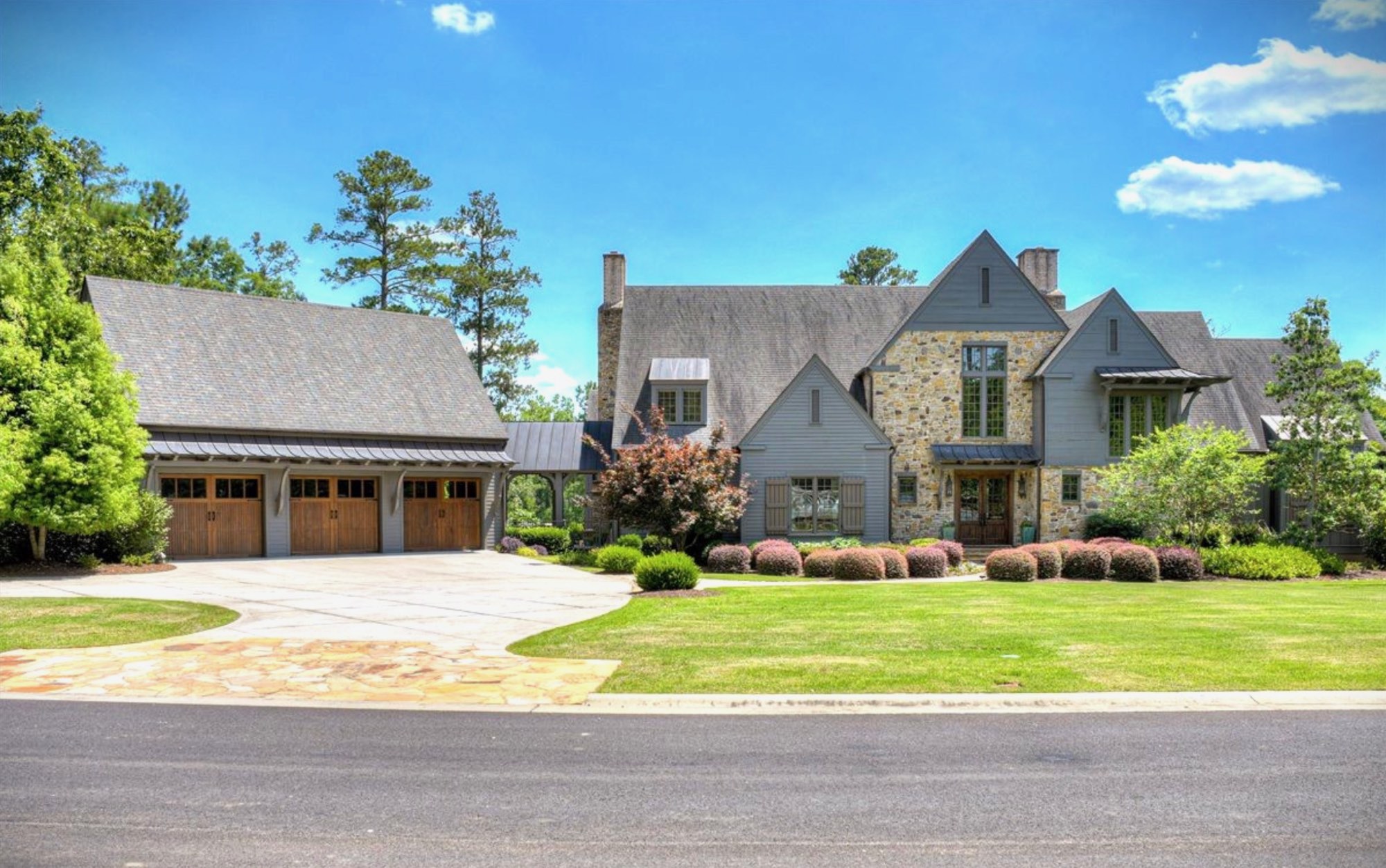 A stone and shingle home on a wide lawn in Augusta, Georgia